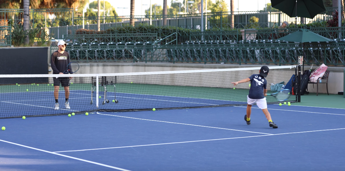Student hitting with coach