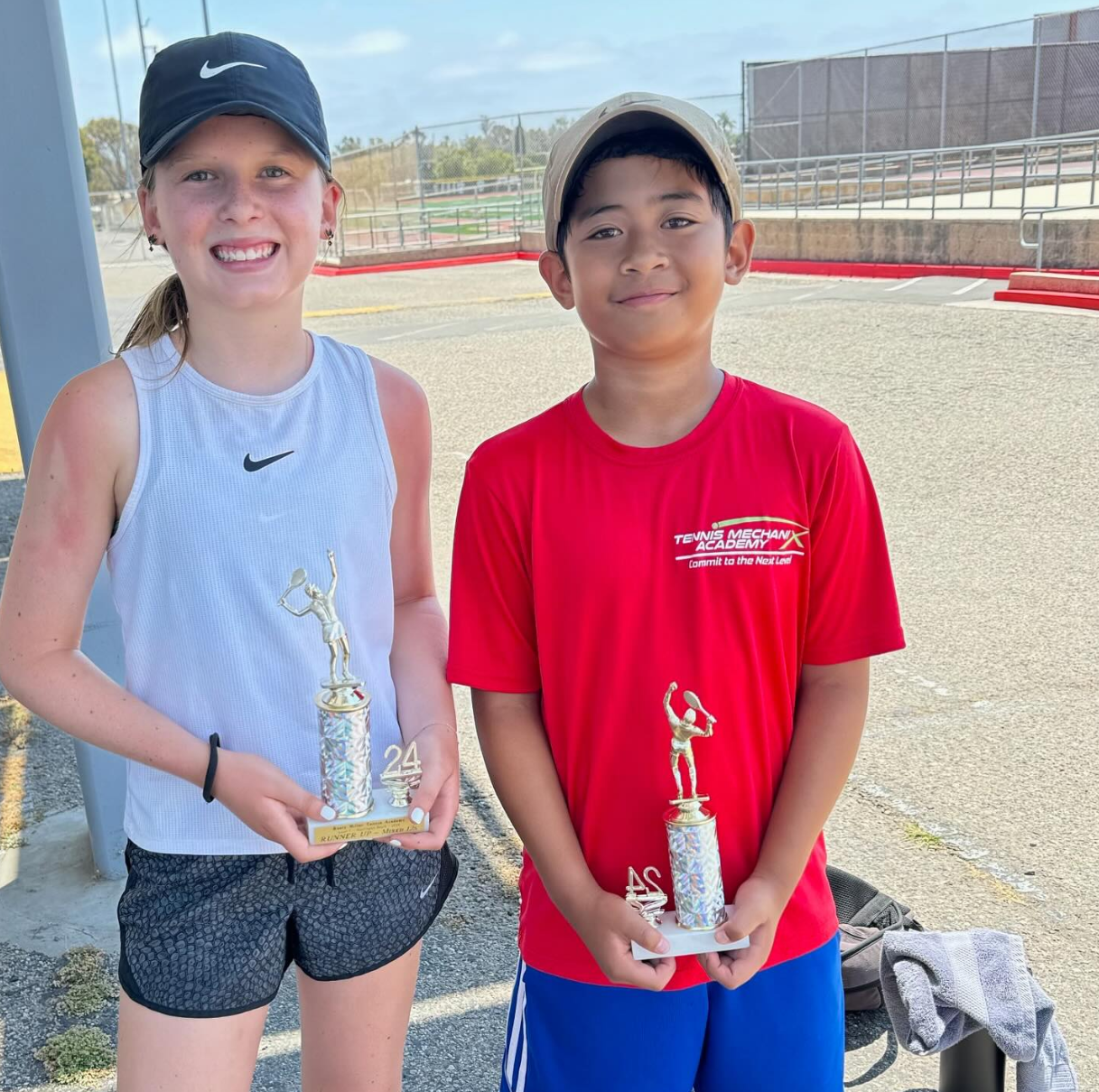 Two students with a trophy