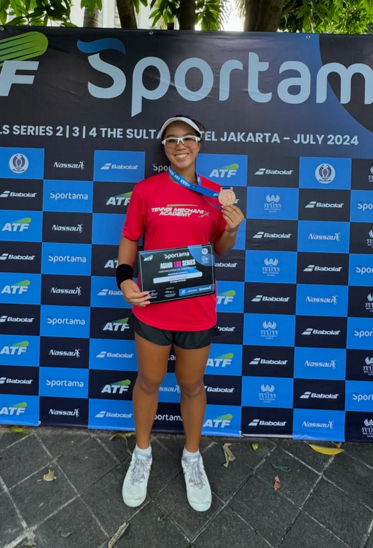 TMX Student with a medal
