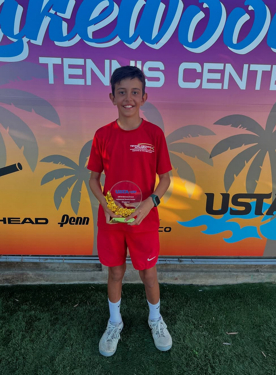 TMX Student holding a trophy