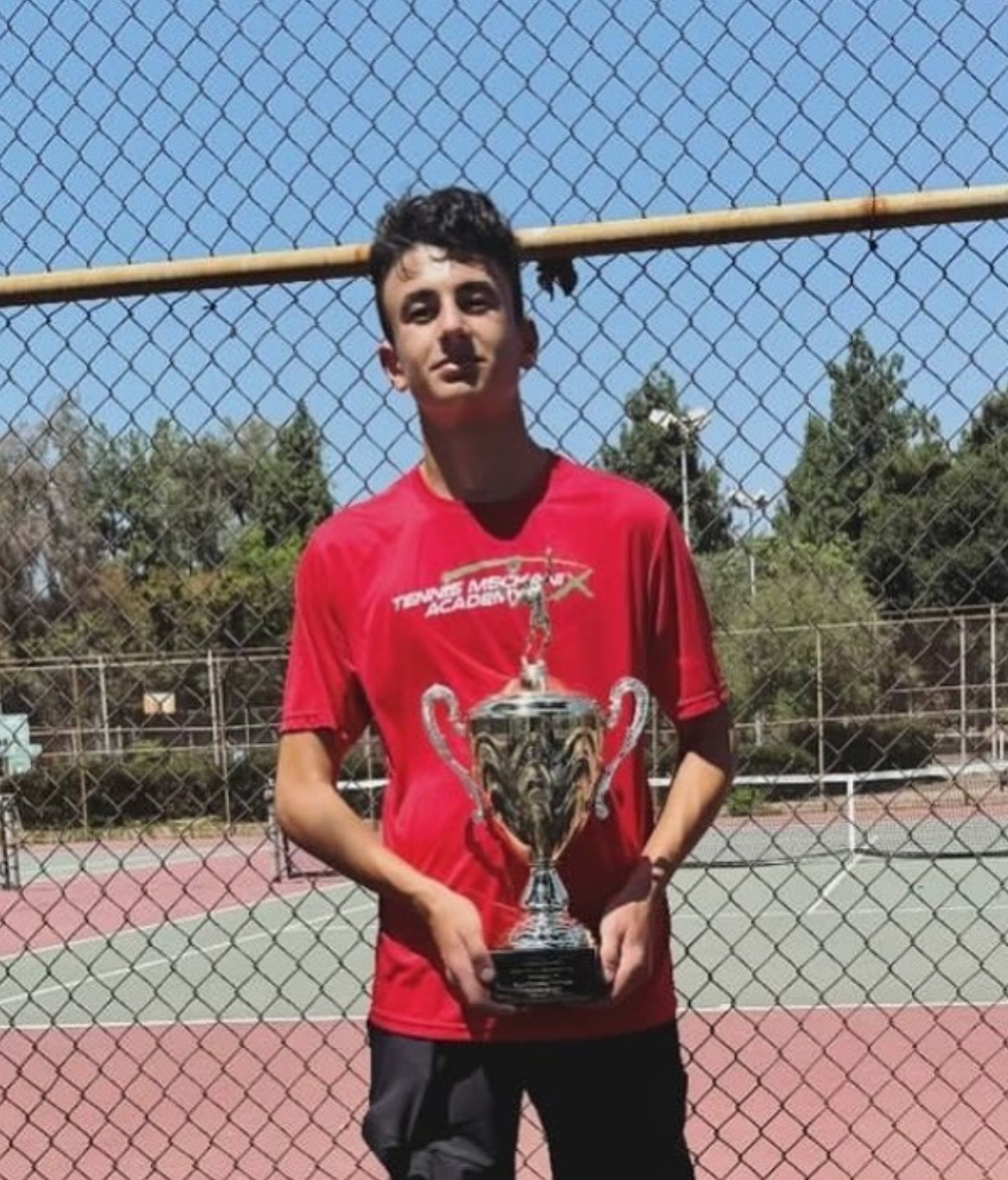 TMX student with a trophy