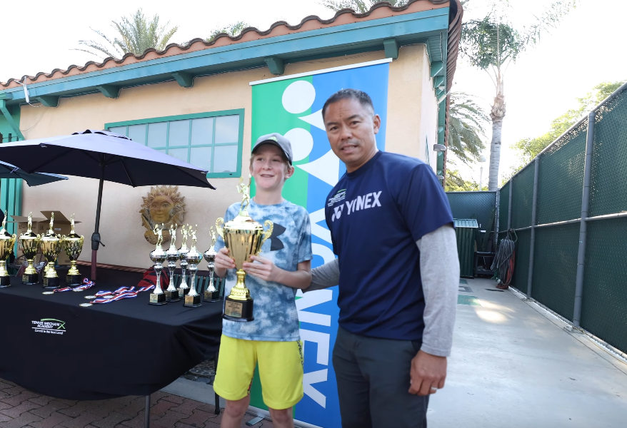Player receiving trophy after a tournament win