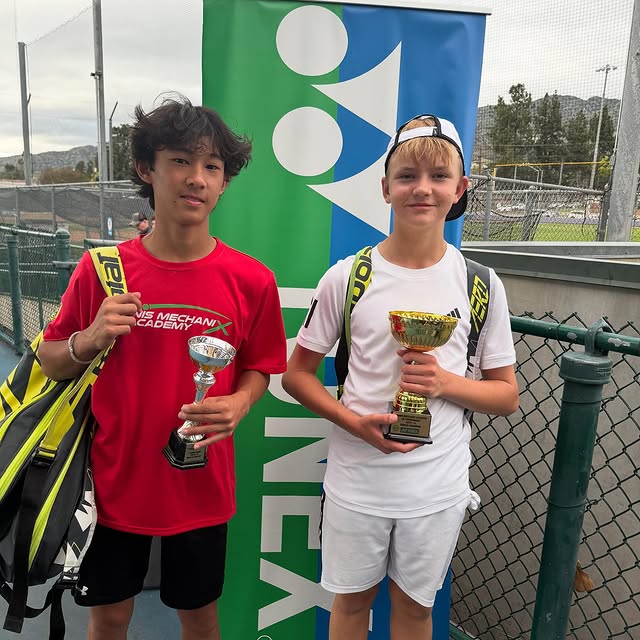 Two students with trophies