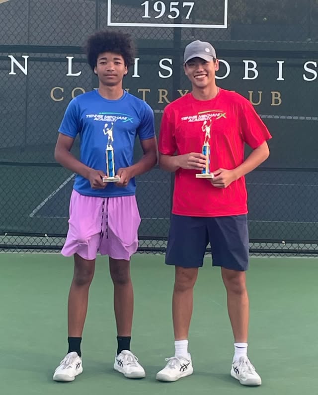 Two students with trophies